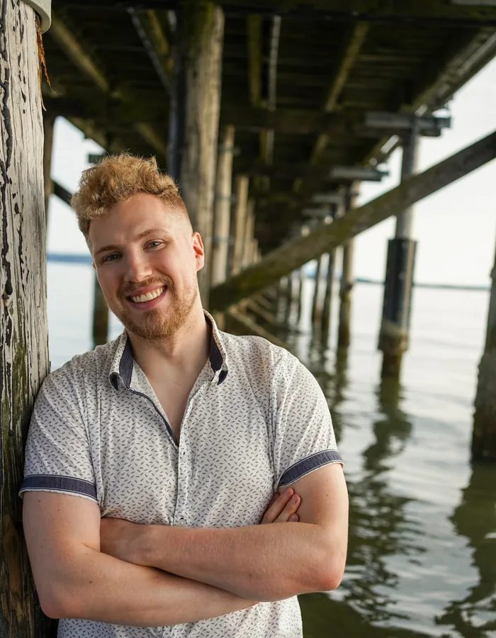 Troy, who designed and built this site, standing under a pier in Vancouver.